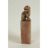 A Chinese pink soapstone seal, the top carved as a fo dog, 4" high