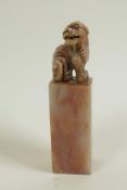 A Chinese pink soapstone seal, the top carved as a fo dog, 4" high