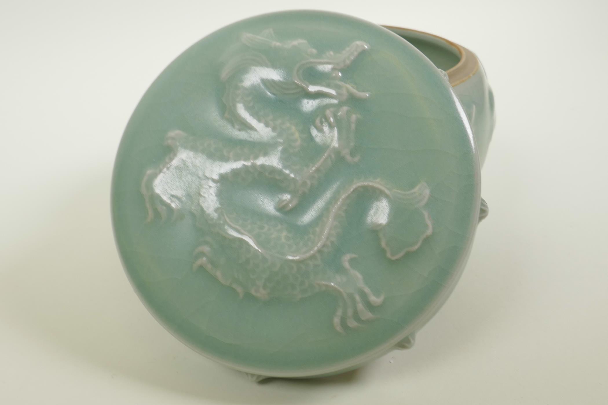 A Chinese celadon crackle glazed porcelain pot and cover with raised underglaze dragon and lotus - Image 3 of 5