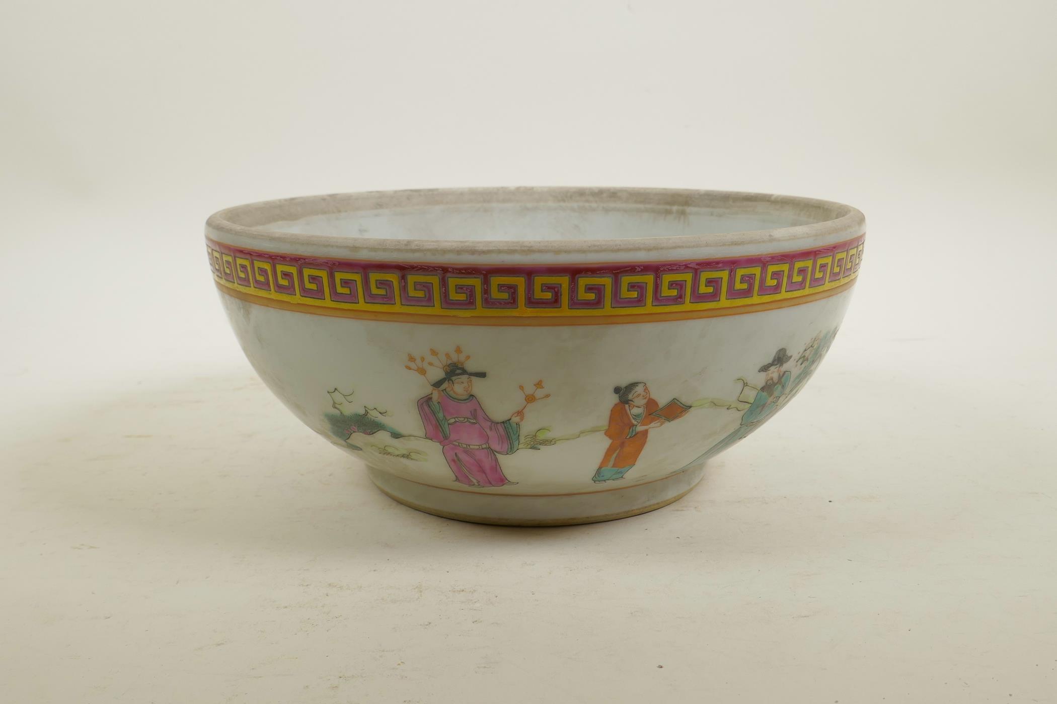 A Chinese famille rose enamel porcelain bowl decorated with brightly robed figures in a landscape,