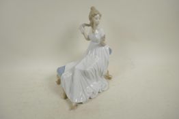 A Spanish D'Art. SA porcelain figure of a girl in a long dress seated on a chaise, 10½" high