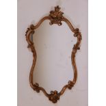 A gilt Rococo style gilt framed wall mirror, 39" x 25"