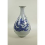 A Chinese blue and white porcelain pear shaped vase decorated in the Ming style depicting dragons