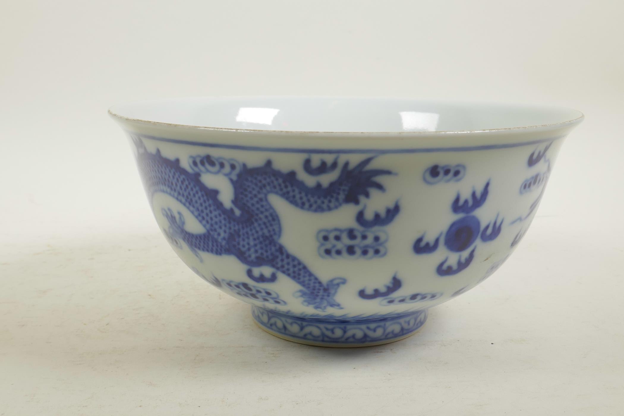 A Chinese blue and white porcelain bowl decorated with two dragons and the flaming pearl, 6 - Image 2 of 7