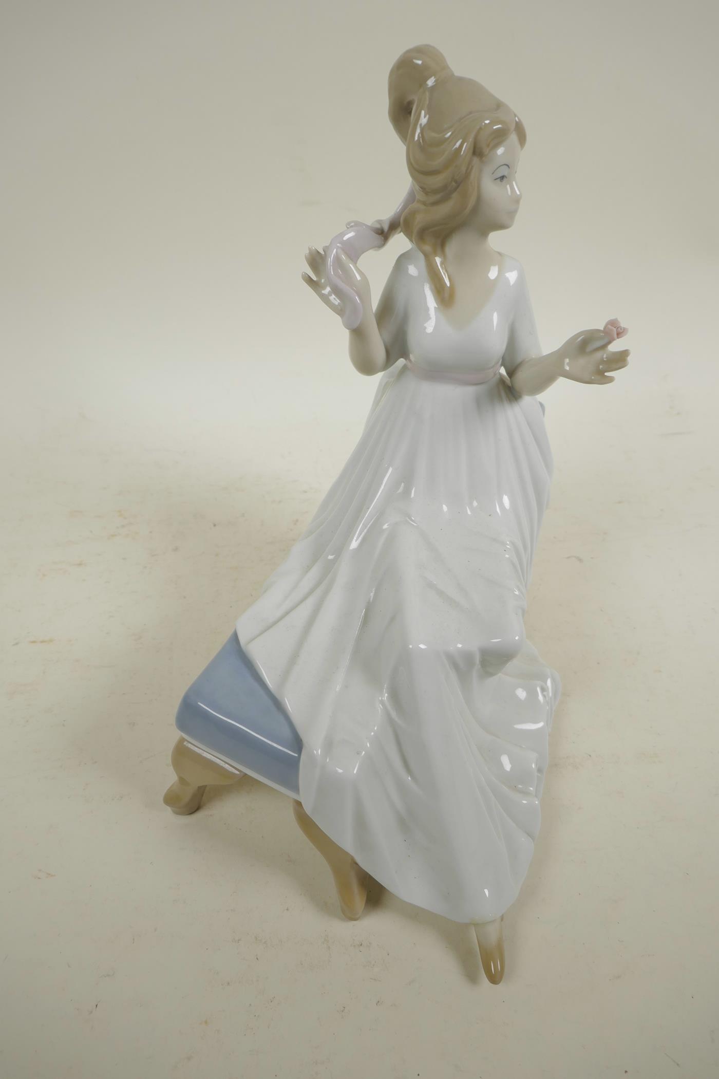 A Spanish D'Art. SA porcelain figure of a girl in a long dress seated on a chaise, 10½" high - Image 3 of 4