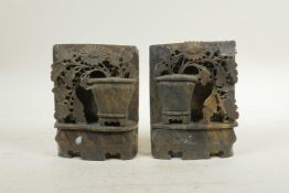 A pair of Chinese carved soapstone bookends, with floral decoration, 4" x 5½"