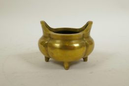 A Chinese polished brass censer with two handles, impressed seal mark to base, 4" x 4"