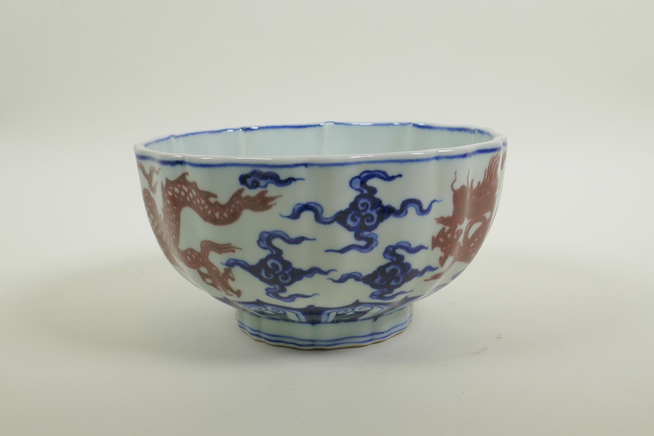 A Chinese blue and white porcelain bowl of lobed form, decorated with iron red dragons to exterior - Image 2 of 5