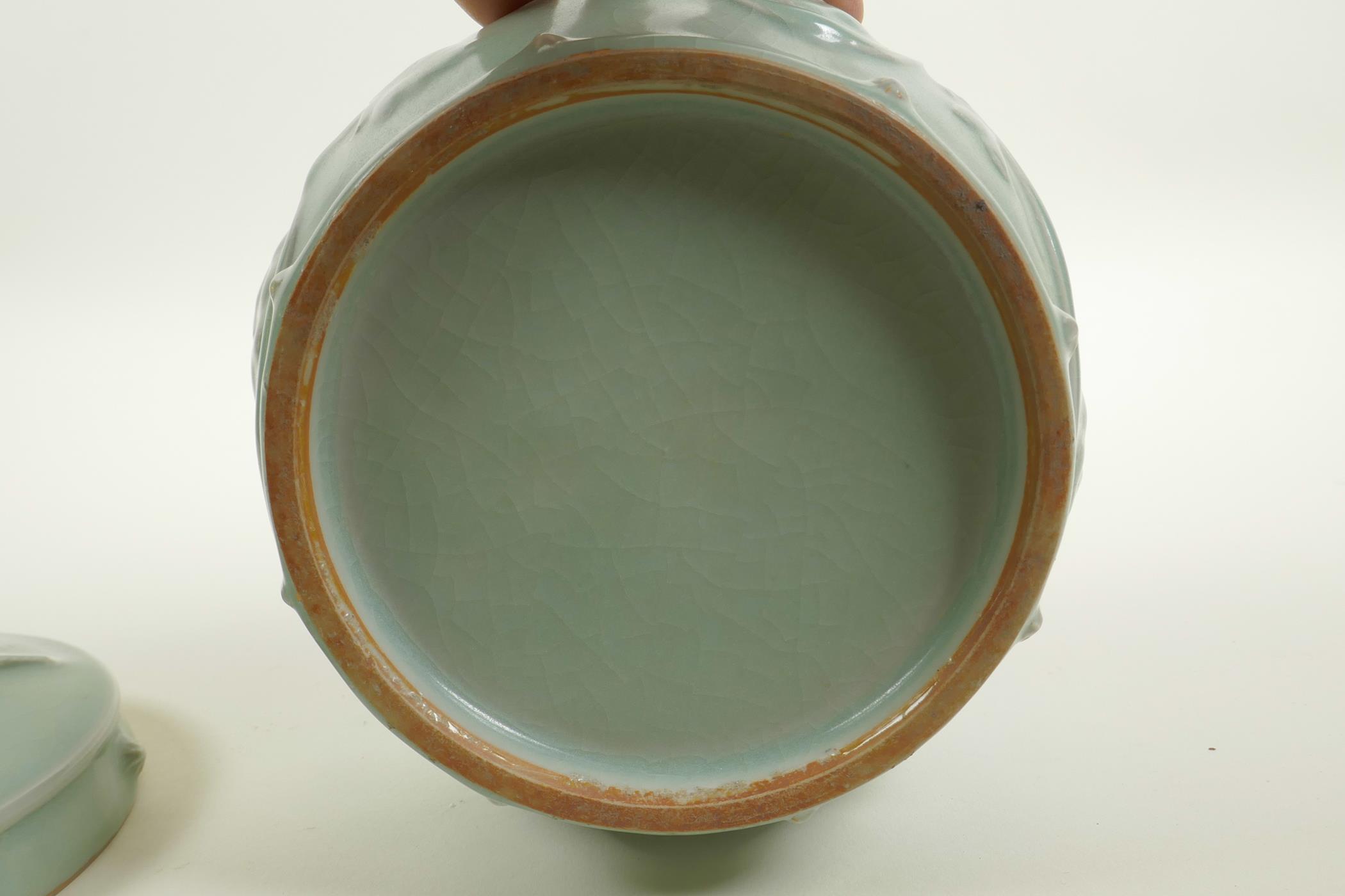 A Chinese celadon crackle glazed porcelain pot and cover with raised underglaze dragon and lotus - Image 5 of 5