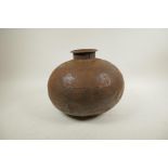 An Indian bulbous iron water pot of riveted construction, 12" diameter