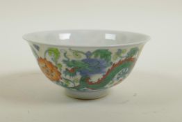 A Chinese doucai porcelain rice bowl decorated with dragons and lotus flowers, 6 character mark to