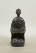 A Chinese bronze card tray in the form of a kneeling figure, 9" high