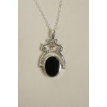 A white metal revolving pendant necklace set with onyx and mother of pearl, 1½" drop