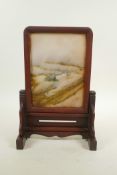 A Chinese hardstone table screen in a wood mount, 11" high, 7½" wide
