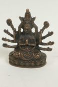 A bronze figure of a Hindu deity, seated in meditation on a lotus throne, 3" high