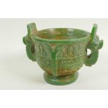 A Chinese carved green hardstone censer with two mask handles on pedestal base carved with birds and