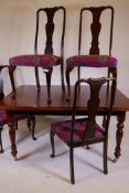 A Victorian style mahogany dining table raised on fluted supports (detachable), and a set of Queen