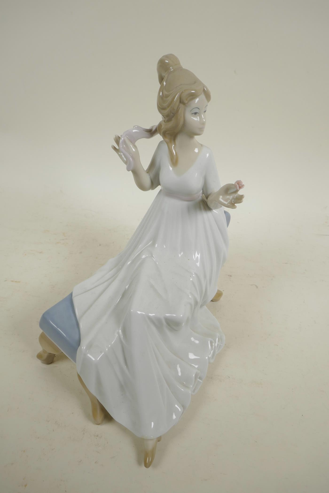 A Spanish D'Art. SA porcelain figure of a girl in a long dress seated on a chaise, 10½" high - Image 4 of 4