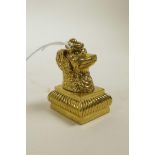 A gilt metal seal with dog's head finial, 1½" high