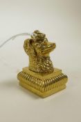 A gilt metal seal with dog's head finial, 1½" high