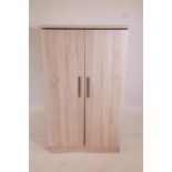 A limed oak style two door cupboard, 30½" x 21", 50" high
