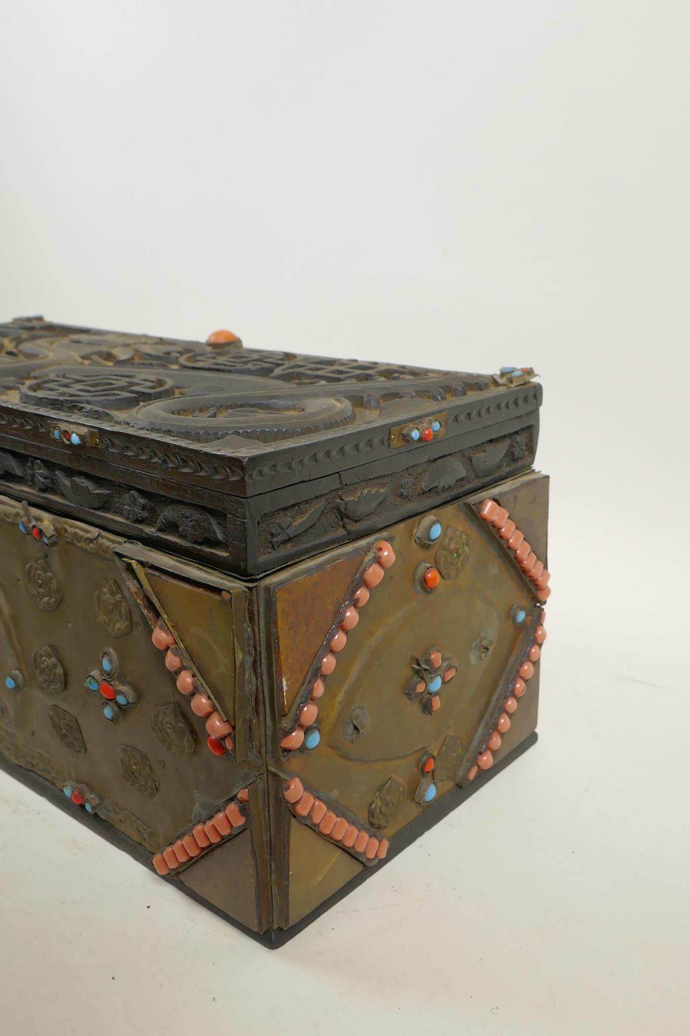 A Sino-Tibetan brass bound carved hardwood casket, with dragon and auspicious symbol decoration, and - Image 4 of 5