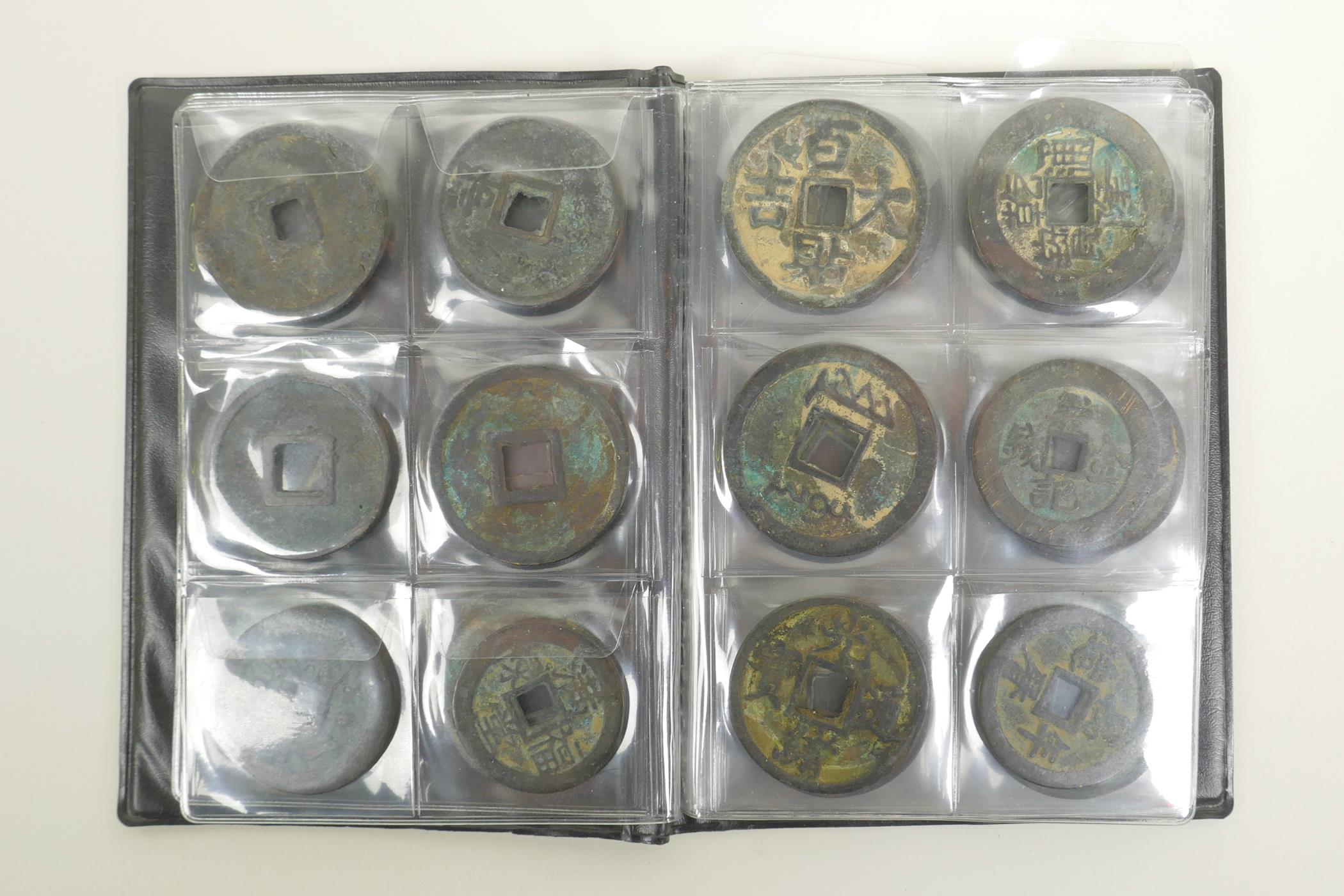 A wallet of Chinese facsimile (replica) bronze coinage, 1½" diameter