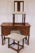 An Ipswich oak four drawer kneehole dressing/writing table, with panelled ends and carved