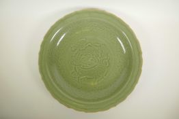 A Chinese Song style olive crackle glazed pottery charger with a lobed rim and incised underglaze