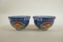 A pair of Korean porcelain rice bowls with floral decoration in the Imari pallette, signed to