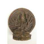 A bronze figure of a multi-armed deity, seated on a lotus throne before a large mandala, 3½" high