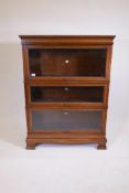 A mahogany Simpoles Chapter bookcase, three sections with glazed doors, raised on base with ogee