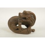 A Chinese carved hardwood dragon, 7" wide