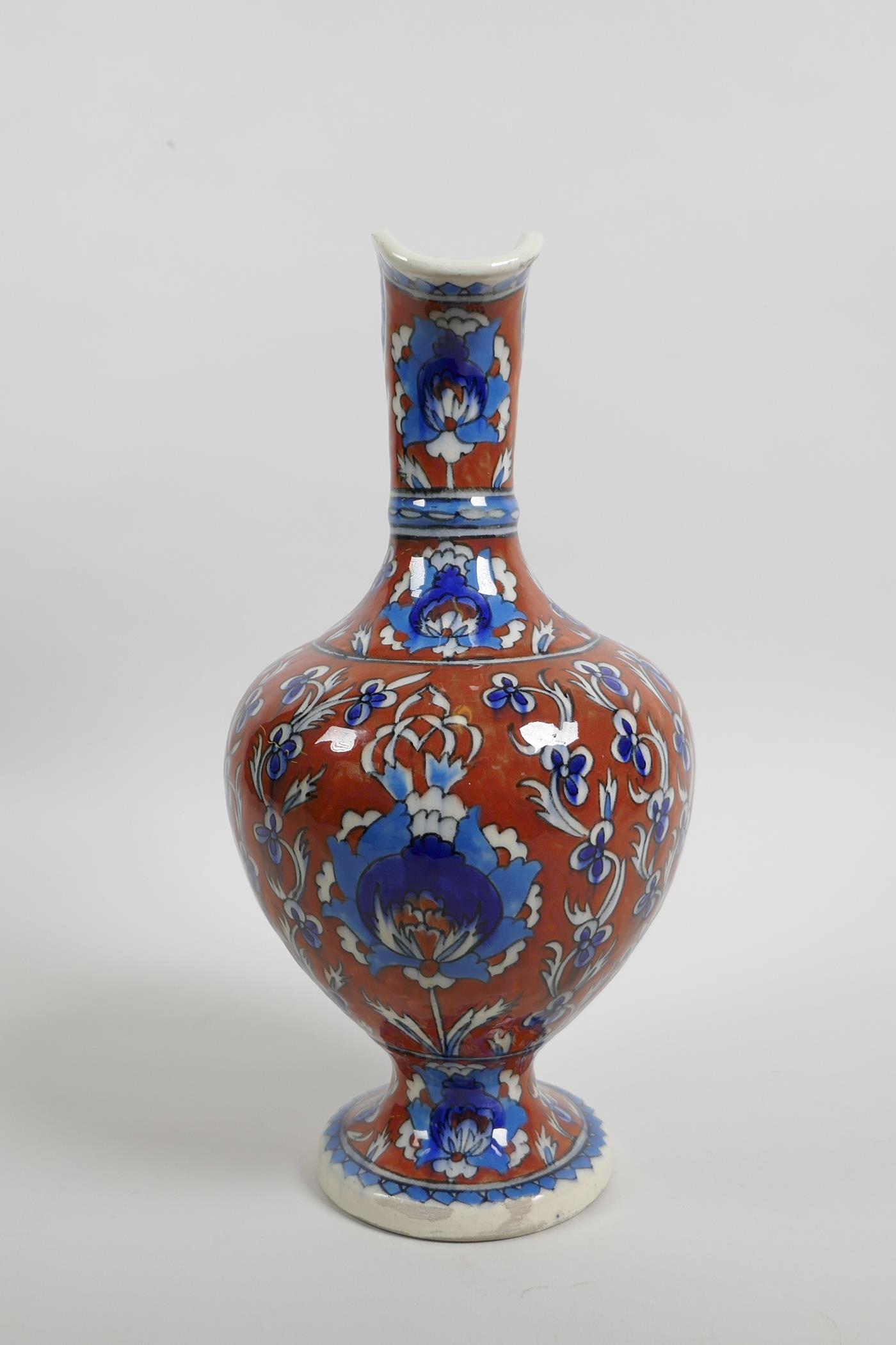 An early C20th Turkish Kutahya pottery ewer with traditional floral decoration, repair to handle, - Image 2 of 7