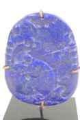 A Chinese carved lapis amulet decorated with exotic beasts, 2½" high