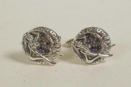 A pair of sterling silver cufflinks decorated with a female nude