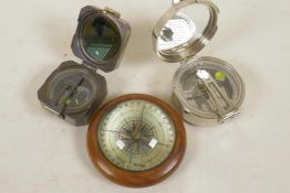 A desk top compass in wooden frame together with two replica brass sighting compasses (desktop 4"