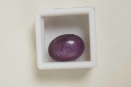 A 35.00ct natural star ruby, purple/pink cabochon, six ray effect, certified by Gemological