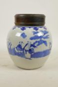 An early C20th Chinese blue and white porcelain ginger jar with a hardwood cover decorated with