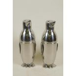 A pair of chrome plated cocktail shakers in the form of penguins, 9" high