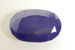 A 304ct natural blue sapphire, oval mixed cut, colour enhanced, certified by Gemological