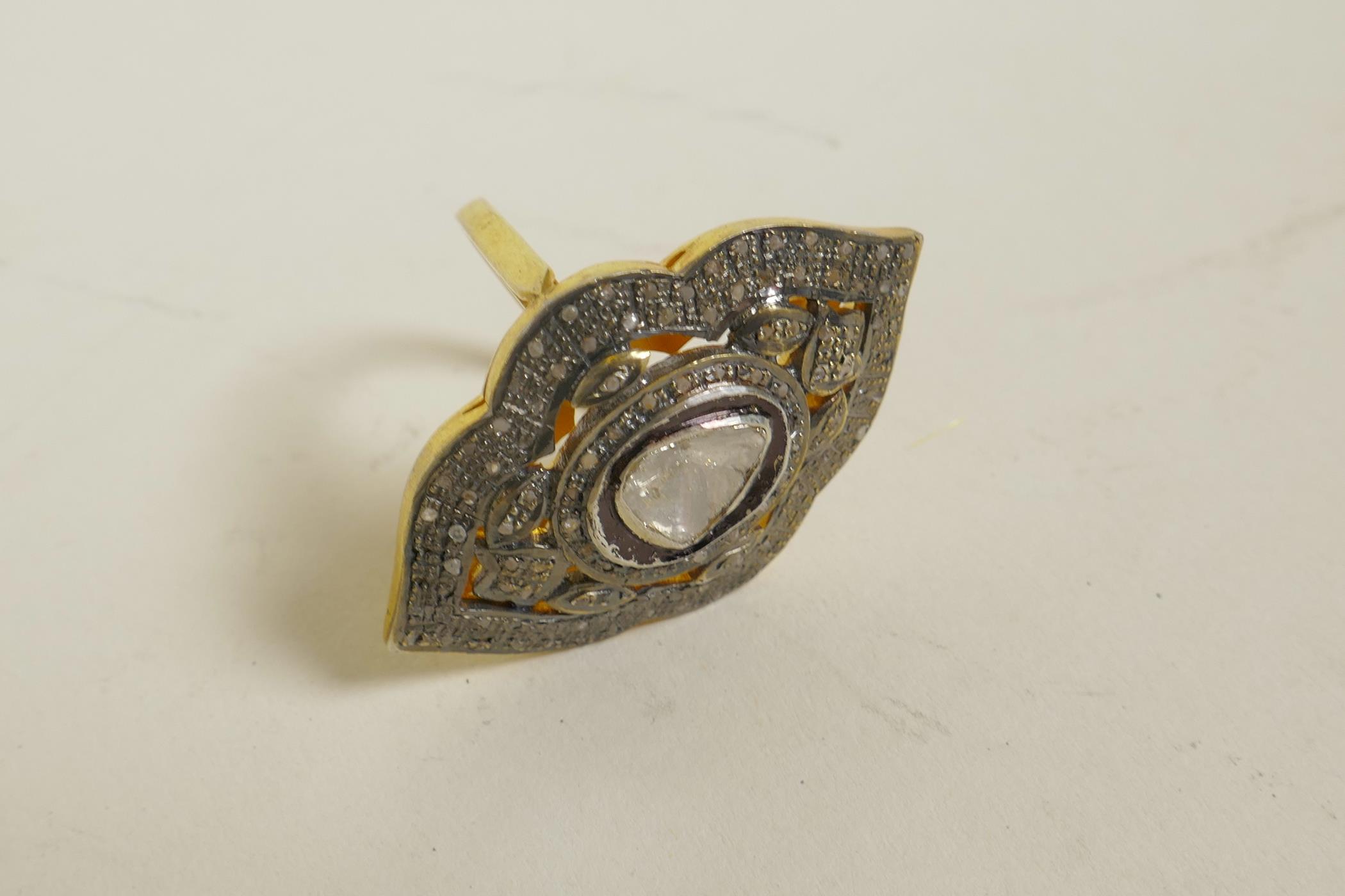 A silver gilt dress ring of diamond form, set with uncut diamonds