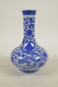 A Chinese blue and white porcelain bottle vase decorated with dragons amongst flowers, seal mark