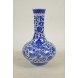 A Chinese blue and white porcelain bottle vase decorated with dragons amongst flowers, seal mark