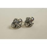 A pair of silver, skull shaped stud earrings