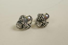 A pair of silver, skull shaped stud earrings