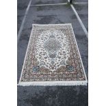 A fine woven ivory ground rug with a multicolour Oriental floral pattern, 59½" x 87"