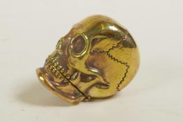 A brass vesta case in the form of a skull, 1½"