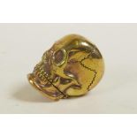 A brass vesta case in the form of a skull, 1½"