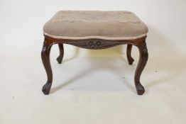 A Victorian cabriole legged stool with carved floral decoration and tapestry upholstery, 24" x 22" x